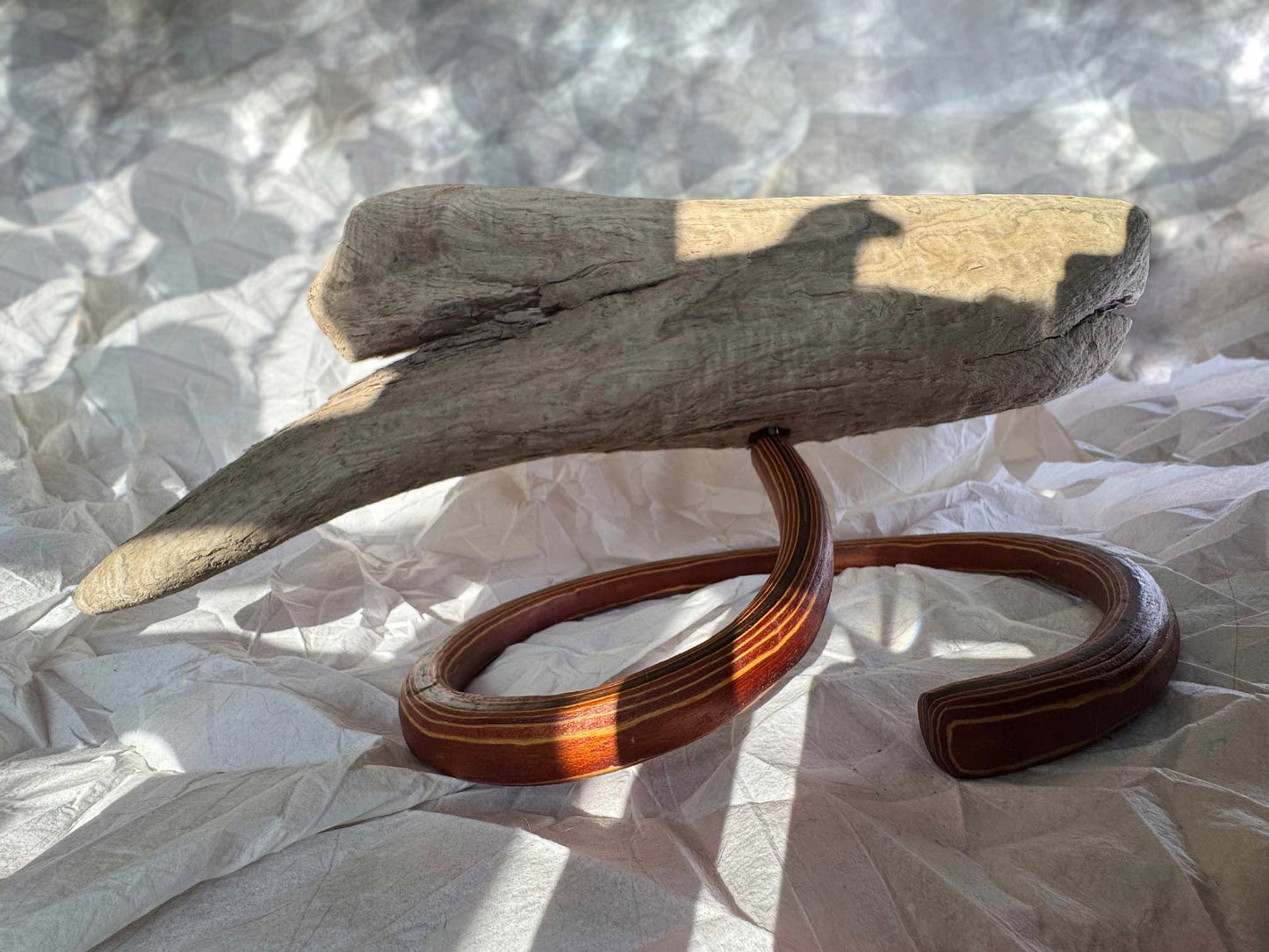 driftwood art piece mounted on laminated curved stand